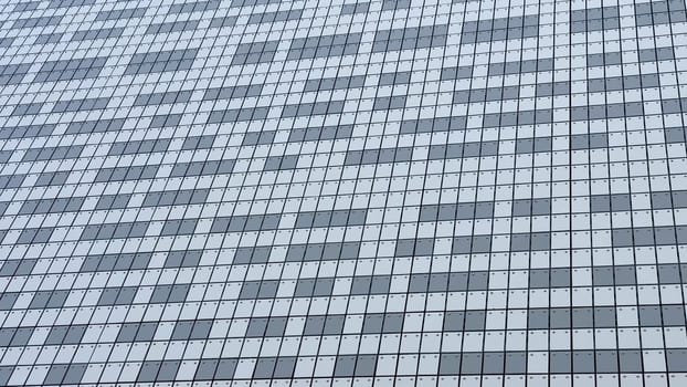 The stylish and striking facade of a modern building showcases a beautiful mosaic composed of gray and white tiles