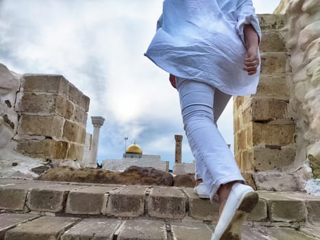 Contemplative moment as a mature woman explores ancient ruins, capturing the essence of travel and adventure in her lifestyle blog.