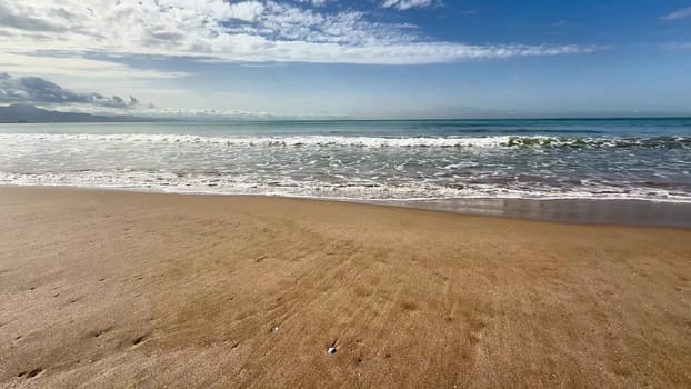 Gentle sea waves on a sandy beach. High quality 4k footage