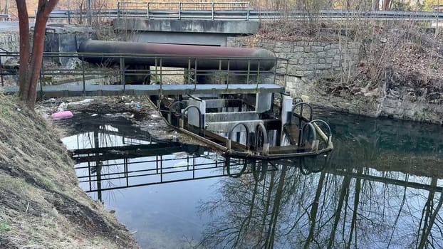 A serene waterway scene featuring industrial elements and stunning reflections. Nature meets machinery.