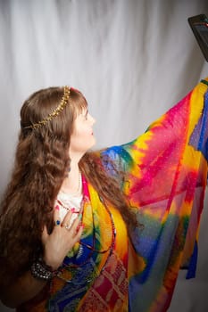 Blonde woman showcases her elegance in a colorful sari during an Indian-inspired photoshoot, exuding confidence and grace while posing.