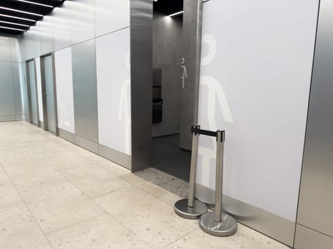 Modern public restroom entrance with clear male and female symbols and barrier free access offers hygienic toilet. Solutions for families and people with disabilities in urban spaces