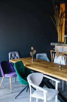 Modern Dining Space Featuring Colorful Chairs and a Wooden Table with Minimalist Decor Elements