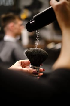 Preparing Shaving Brush with Talcum Powder by Barber in a Stylish Barbershop for Grooming Service