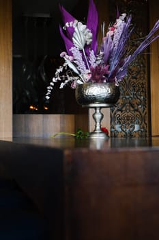 Vibrant Floral Arrangement in Decorative Vase on Wooden Table in Modern Interior Space