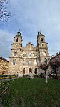 Innsbruck, Austria - March 28, 2025: Historic Jesuit Church with twin towers and stunning architecture located in the city center of Innsbruck, representing cultural heritage