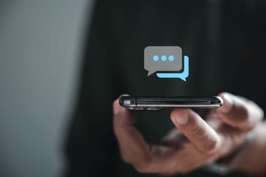 Man engagement in live chat through his smartphone symbolizes fusion of social networking and chatting concepts. Chat box icons pop up, seamless integration of technology in social medimarketing.