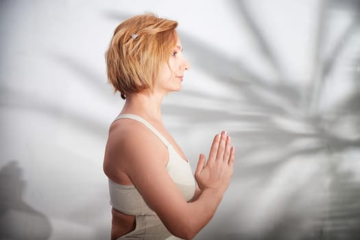 A person is engaged in yoga, focusing on mindfulness and balance in a serene indoor setting.
