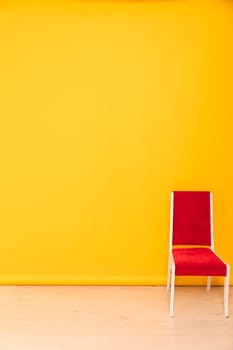 One red chair in the interior of a yellow room