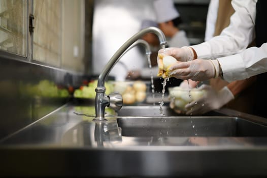 Smiling young chefs learning kitchen hygiene and teamwork in a professional cooking school.