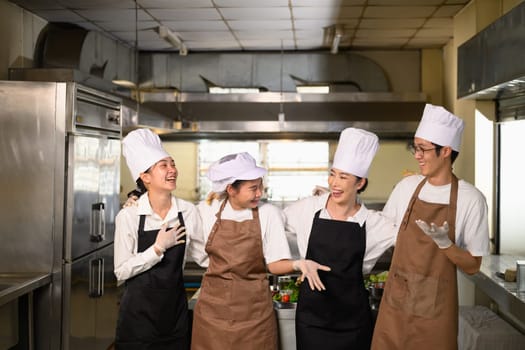 Cooking school classmates sharing a joyful conversation after class.
