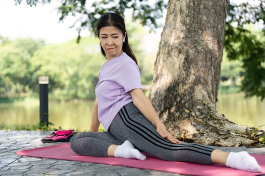 A woman demonstrates a yoga pose outdoors, enhancing flexibility and promoting a healthy lifestyle in a natural setting.