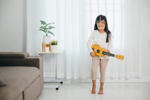 An Asian girl stands in a stylish living room, ukulele in hand, her expression full of joy. The scene reflects her passion for music and adds a charming artistic touch to the modern setting.