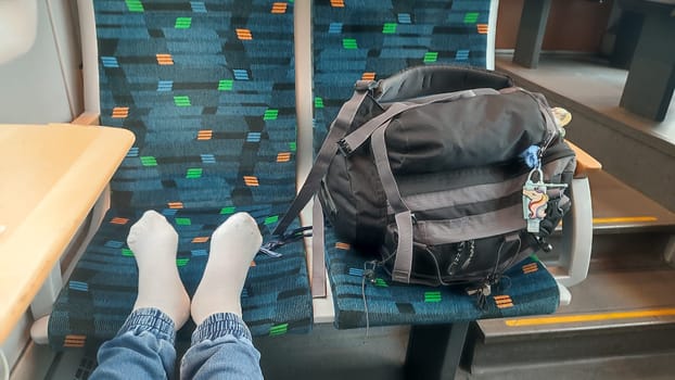 Benesov Czech Republic Europe October 18 2024 Feet backpack train women travel tourism transport editorial shotlisttravel table objects sitting waiting . High quality photo