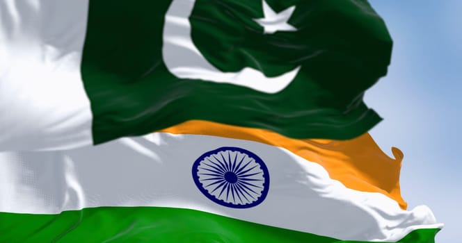 Pakistan and India national flags waving on a clear day. 3d illustration render. Selective focus. Rippling fabric