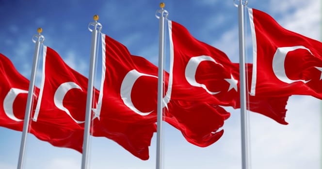 Turkish national flags waving in the wind on a clear day. Red flag with white crescent and a star. 3D illustration render. Fluttering fabric. Selective focus