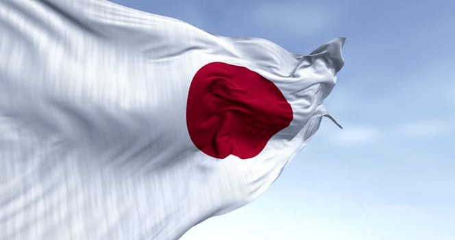 Japan national flag waving in the wind on a clear day. Red disc on a white field. Japan is an island country in East Asia. 3D illustration render. Rippled textile. Selective focus. Waving flag
