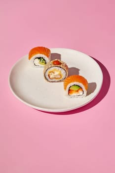 Sushi pieces with various fillings are beautifully arranged on a ceramic plate, creating an enticing culinary scene