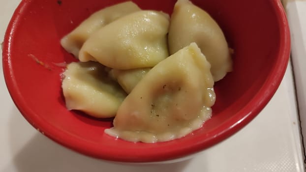 Dumplings red bowl food ingredients kitchen cooking sweet potato fries plate object one tasty home homemade restaurant cafe bar table . High quality photo red yellow white