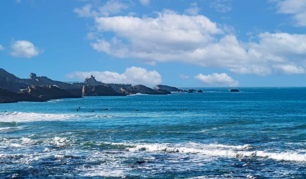 The ocean is calm and the sky is blue. The water is clear and the waves are small, Biarritz, France