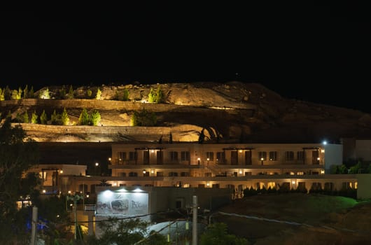 Petra, Jordan - 9 November 2024: Dramatic sunset sky over the hills outside Petra city with Basin restaurant and Guest House hotel