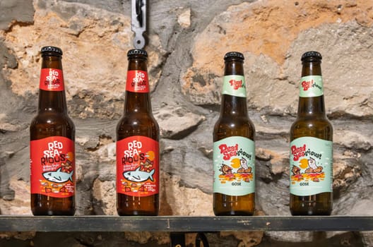 Madaba, Jordan - 9 November 2024:Red Sea-rious and Dead Sea-rious local craft beers on shelf in restaurant in town