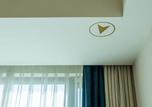Gold colored arrow pointing out the direction to Mecca for prayer in modern hotel in Amman Jordan