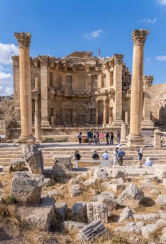 Jerash, Jordan - 11 November 2024: Tourists view the Nymphaeum or public fountain on Cardo Maximus in Jerash