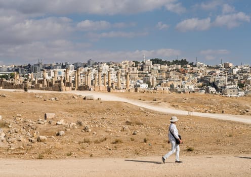 Tourists walking between monuments in Jerash, a Greco-Roman well preserved city in Jordan