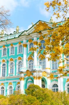 the incredibly picturesque facade of the Winter Palace through the branches of trees on a clear spring day, the heritage of Russia, the most famous landmark of St. Petersburg, the museum. High quality photo