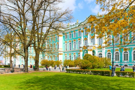 Russia,St. Petersburg, 10 May 2025: the incredibly picturesque facade of the Winter Palace through the branches of trees on a clear spring day, the heritage, the most famous landmark, the museum. High quality photo