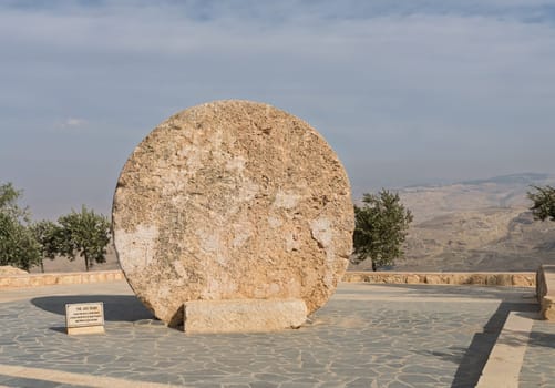 Abu Badd rolling stone used to fortify door of monastery in Faisaliyah Jordan on display on Mount Nebo Jordan