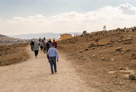Tourists walking between monuments in Jerash, a Greco-Roman well preserved city in Jordan