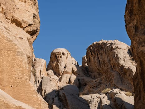 Burial caves looking like ghostly face in the hills on walk called Bab As-Siq in Petra