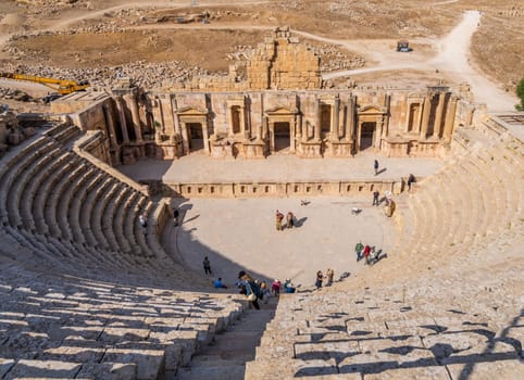 Jerash, Jordan - 11 November 2024: Tourists on the seats above the stage of South Theater in Jerash, a Greco-Roman well preserved city in Jordan