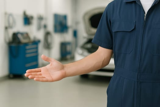AI generated image of a skilled auto mechanic in work uniform gesturing to invite customers into well-equipped car repair garage, showcasing professional automotive services and maintenance solutions.
