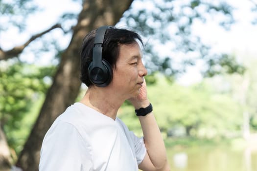 A senior man listens to music in a park, emphasizing the importance of wellness and mental health through music.
