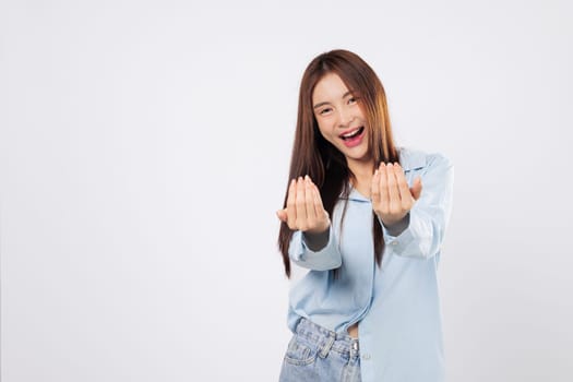 Come here motion made by inviting woman, second woman extends her palm with friendly eyes and soft gesture, both shown isolated on a white background.