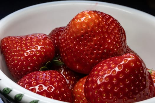 Wild strawberry with ripe fruit in close up