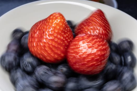 Wild strawberry and blueberry with ripe fruit in close up