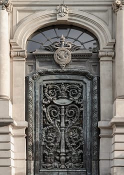 France, Paris - May 03, 2025 - Magnificent entrance facade door of The Paris Chamber of Commerce and Industry building (Chambre de commerce de Paris) is a French chamber of commerce that supports businesses in Paris and the ile-de-France region. It located at Friedland avenu, use it as your Wallpaper, Poster and Space for text, Selective focus.