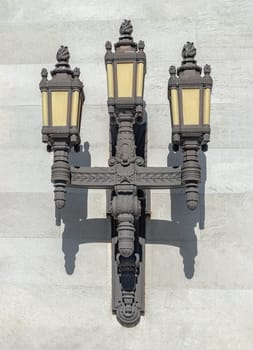London, UK - May 13, 2025 - Classic Art Deco style Black Cast Iron Lanterns on the wall by the entrance of the Freemasons' Hall in London. Vintage ornate lamps on the exterior wall is the headquarters of the United Grand Lodge of England and the Supreme Grand Chapter of Royal Arch Masons of England, British architectural heritage, use it as your Wallpaper, Poster and Space for text, Selective focus.
