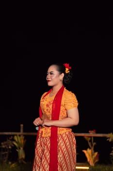 gorgeous Balinese woman showing and performing traditional dress from Indonesia at the fashion festival