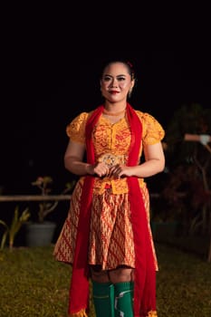 gorgeous Balinese woman showing and performing traditional dress from Indonesia at the fashion festival