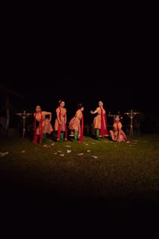 Javanese dancers with beautiful makeup and traditional costume while dancing the traditional dance on the stage inside the village show