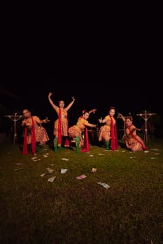 Javanese dancers with beautiful makeup and traditional costume while dancing the traditional dance on the stage inside the village show