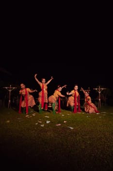Javanese dancers with beautiful makeup and traditional costume while dancing the traditional dance on the stage inside the village show
