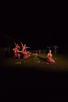 Portrait of Balinese dancer while dancing on the stage with traditional costume and makeup during the competition at the festival