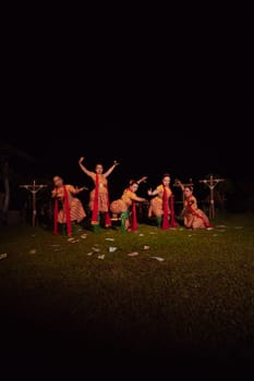 Javanese dancers with beautiful makeup and traditional costume while dancing the traditional dance on the stage inside the village show