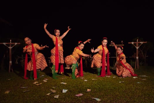Javanese dancers with beautiful makeup and traditional costume while dancing the traditional dance on the stage inside the village show